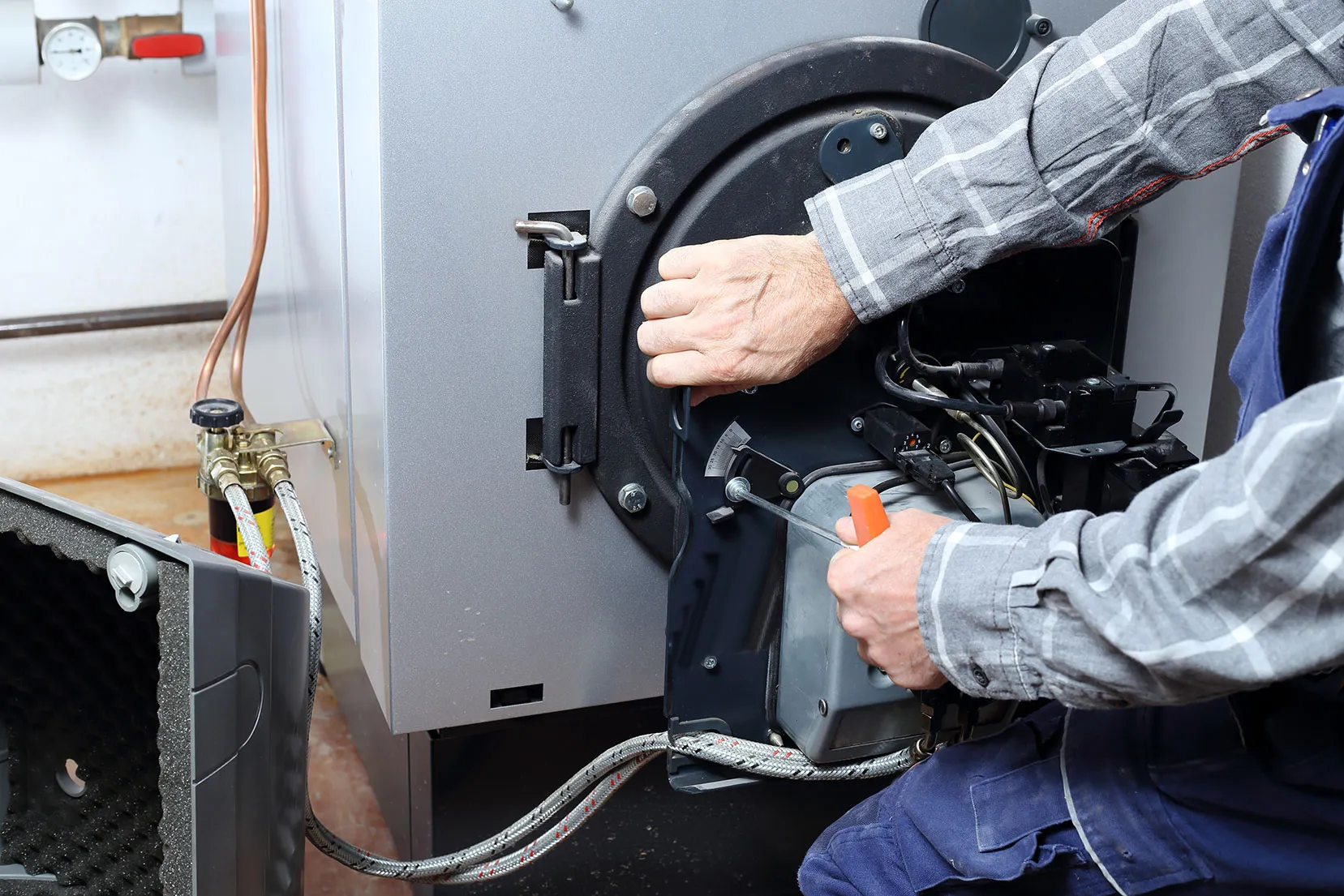 A man working on a machine with a wrench.